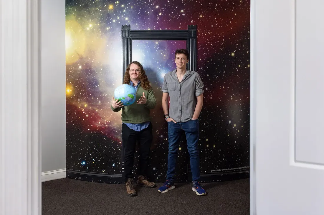 Eric Coughlin and Walter Freeman standing in Holden Observatory. They are both professors of physics in Syracuse University’s College of Arts and Sciences.